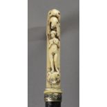 A 19th century European walking cane in carved ebony and ivory