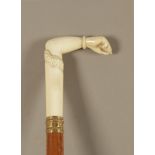 A 19th century possiibly Indian walking cane in carved fruitwood and ivory