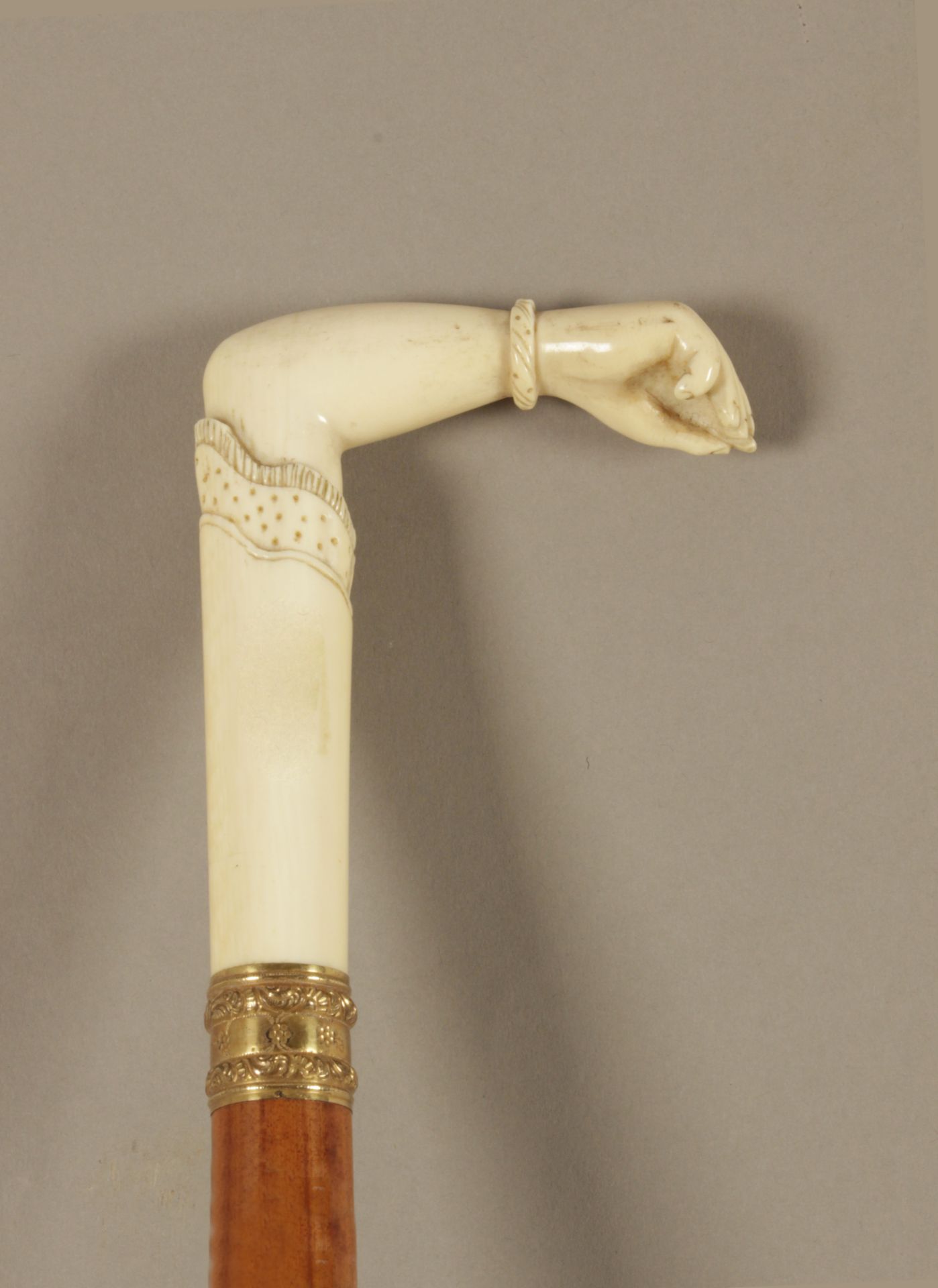 A 19th century possiibly Indian walking cane in carved fruitwood and ivory
