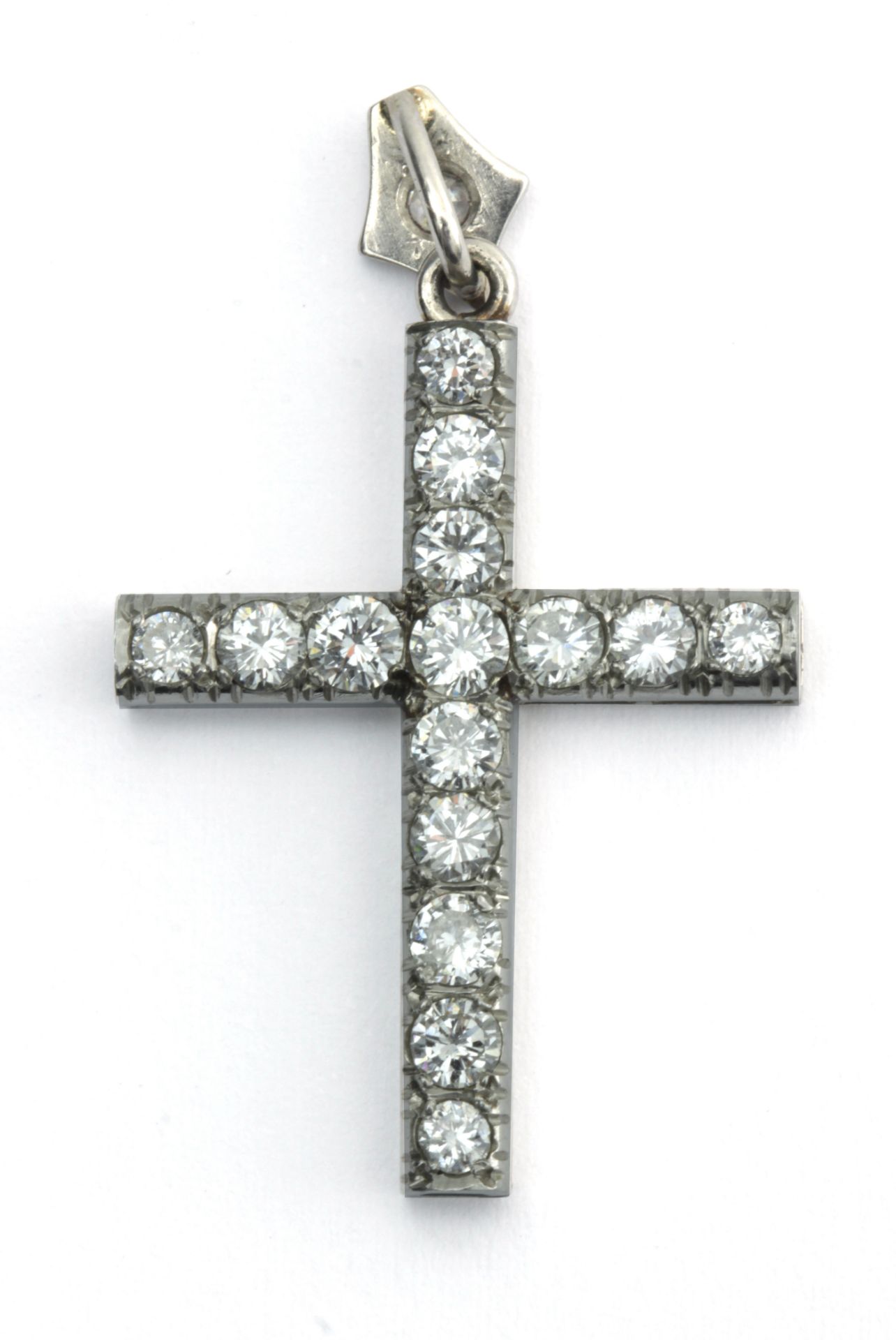 A brilliant cut diamond pendant cross in an 18k. white gold setting