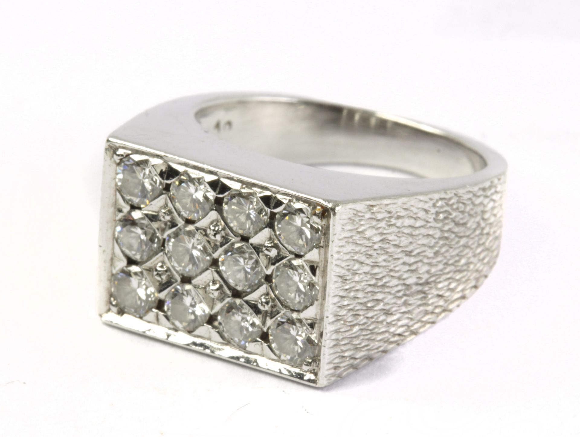 A brilliant cut diamond signet ring in platinum