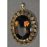 A smoky quartz pendant brooch with an 18k. yellow gold setting