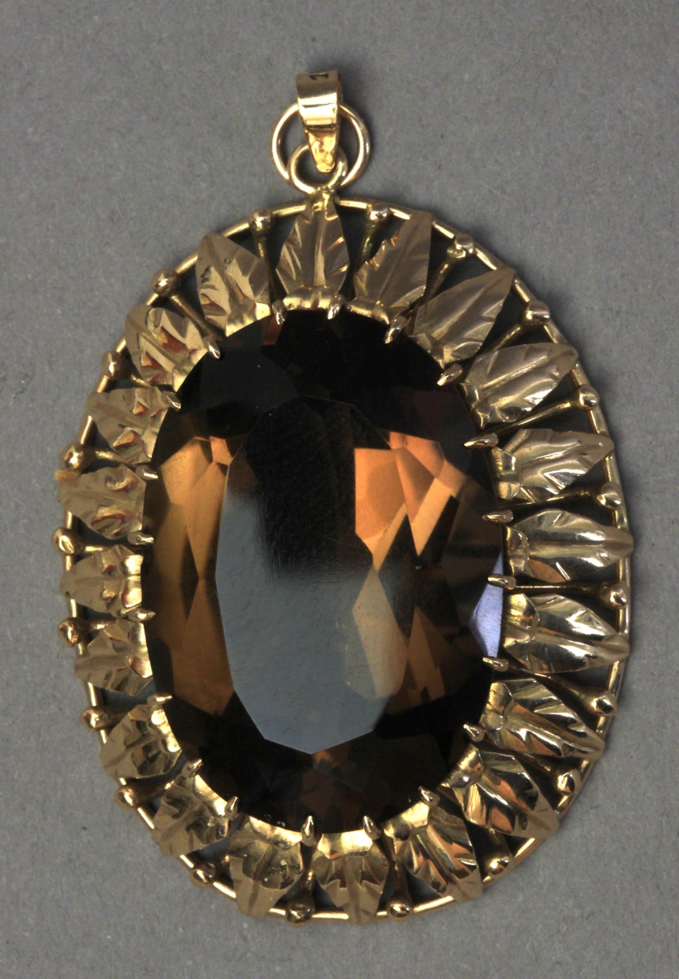 A smoky quartz pendant brooch with an 18k. yellow gold setting