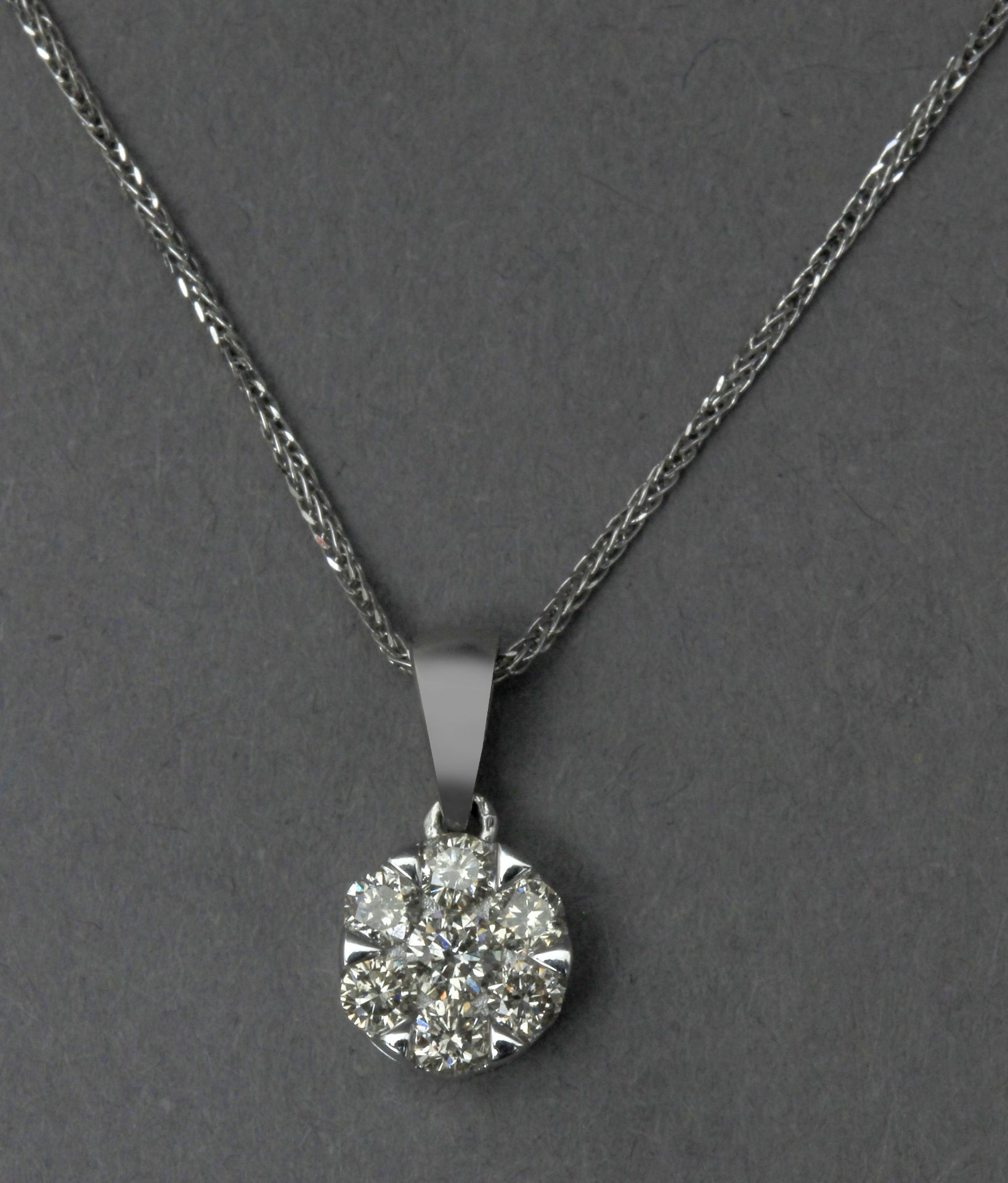 A diamond cluster pendant and 18k. white gold chain
