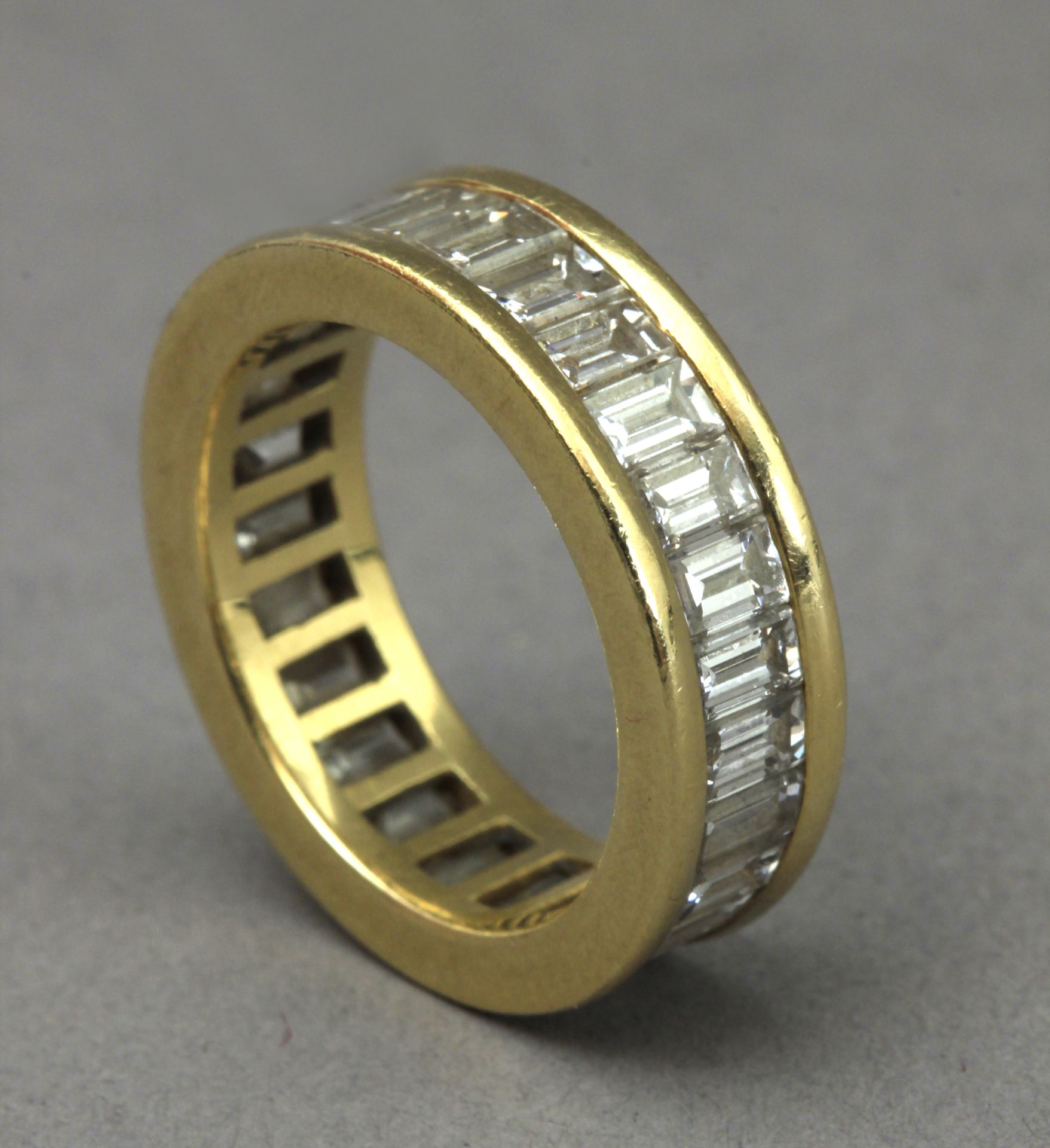 A baguette cut diamonds eternity ring with an 18k. yellow gold setting