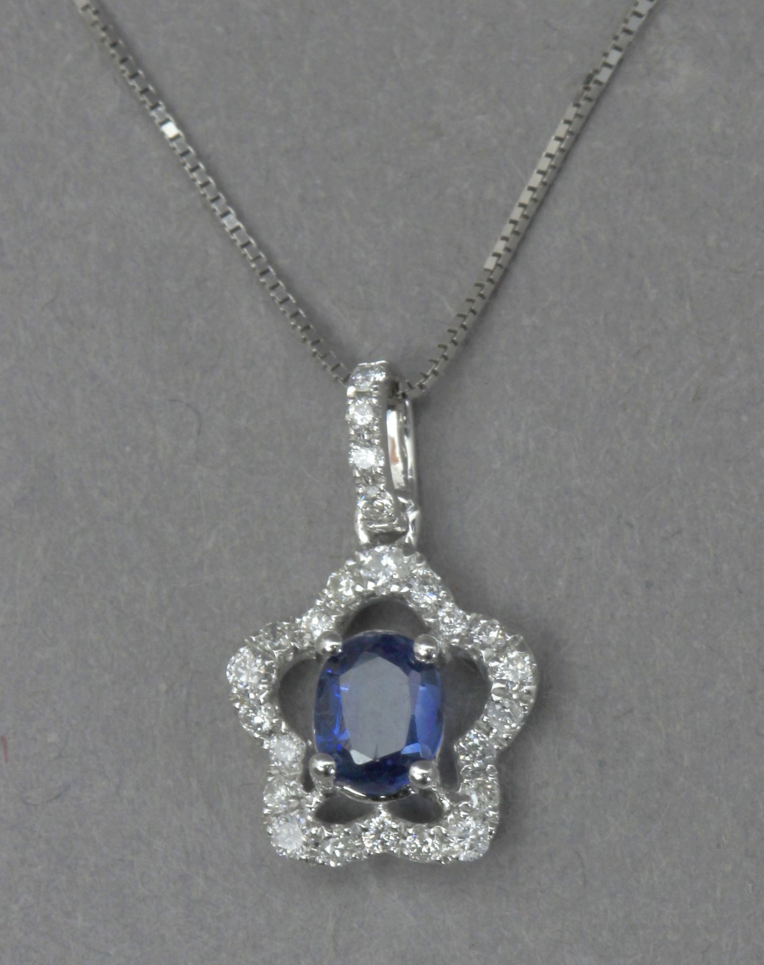 A kyanite and diamond pendant with an 18k. white gold chain
