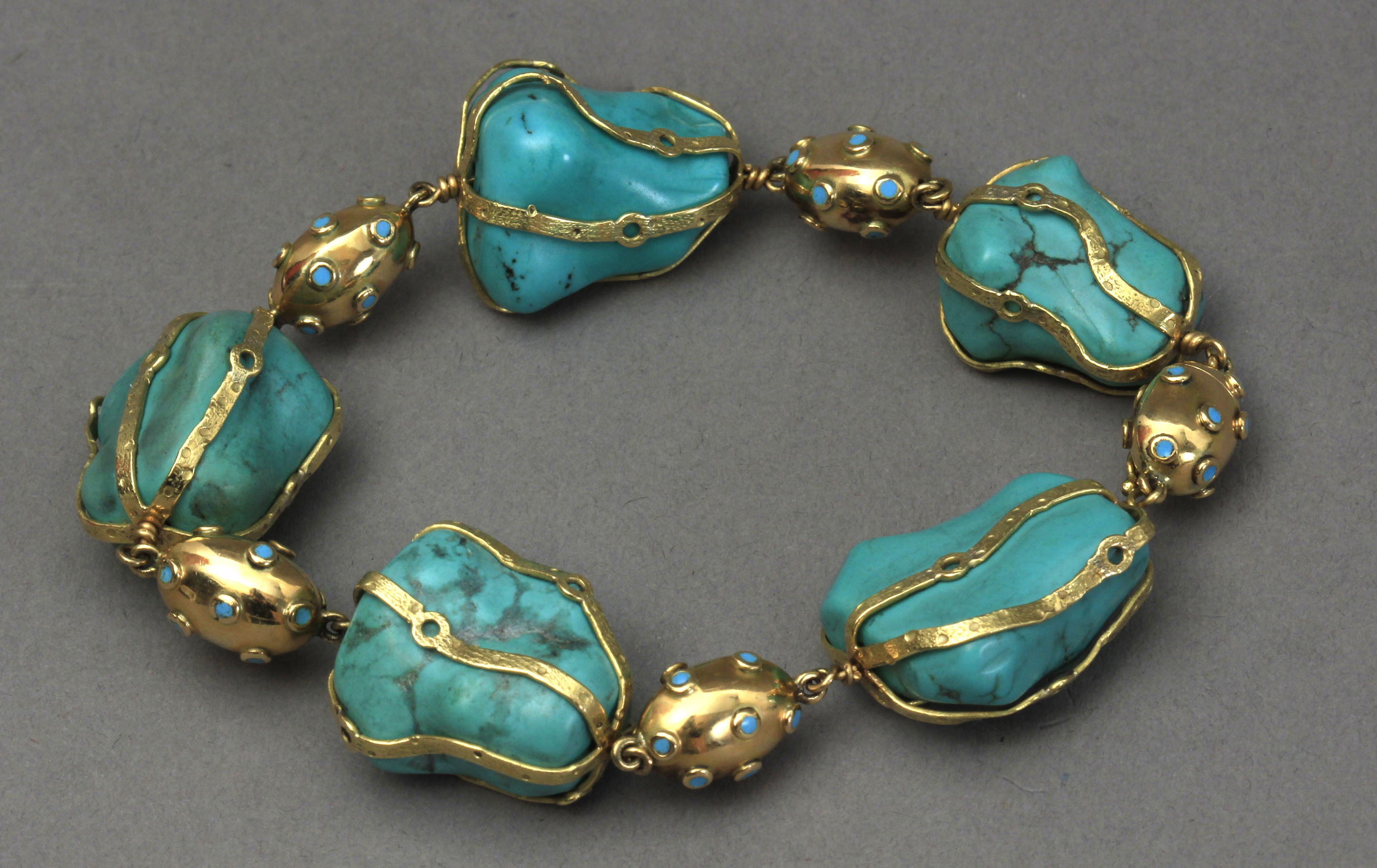 A rough turquoise beads and 18k. yellow gold bracelet