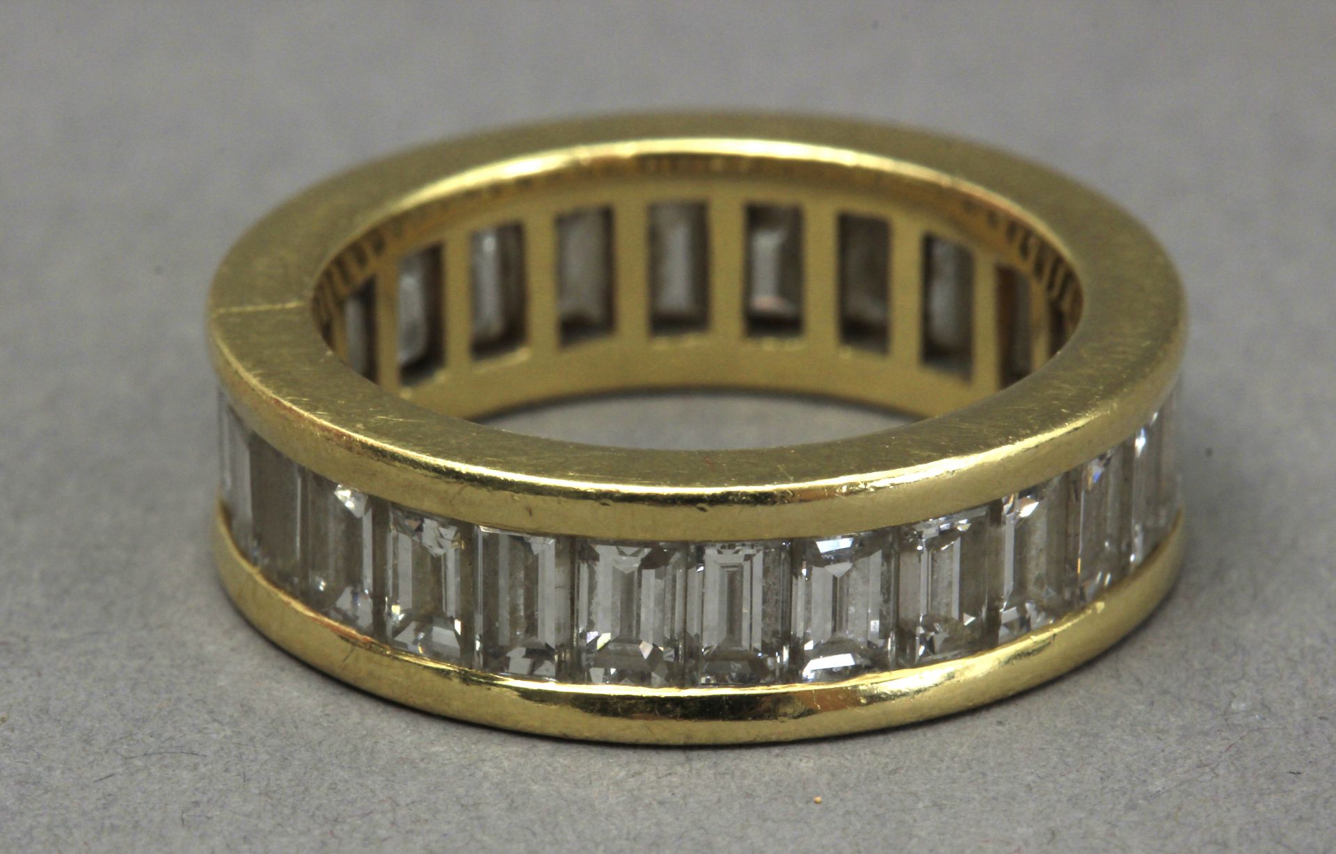 A baguette cut diamonds eternity ring with an 18k. yellow gold setting - Image 2 of 2