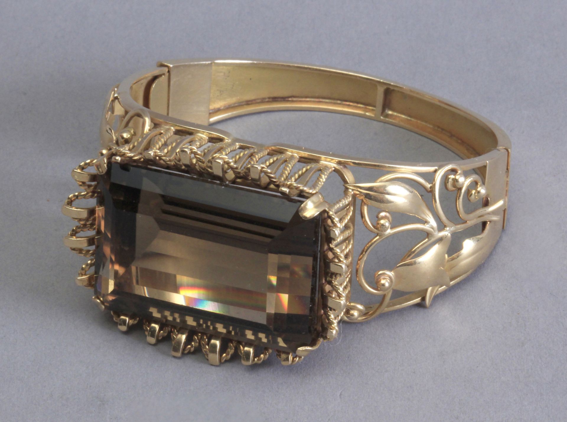 An 18k. yellow gold and a 101 ct. smoky quartz bangle