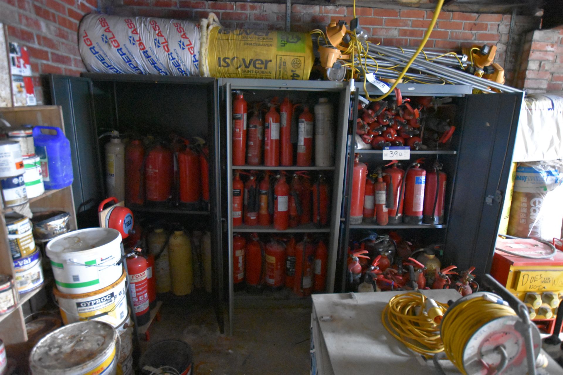 Three double door steel cabinets with contents, including fire extinguishers, and fire