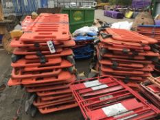 Three Stacks of Plastic Road Safety Barriers