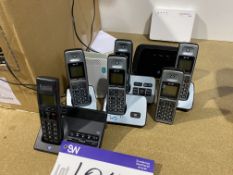 Six BT Mobile Telephones, with five charging stands and three routers  Lot located at Unit C1