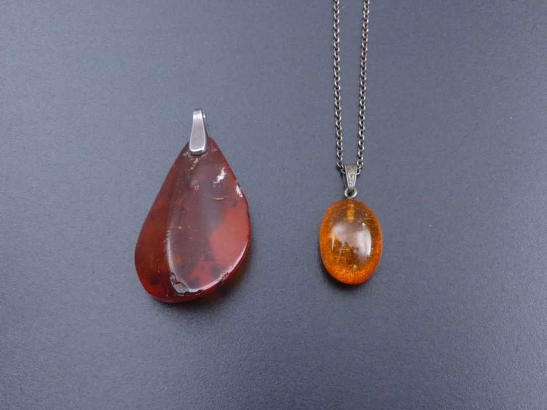 Two amber pendants with chain