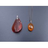 Two amber pendants with chain