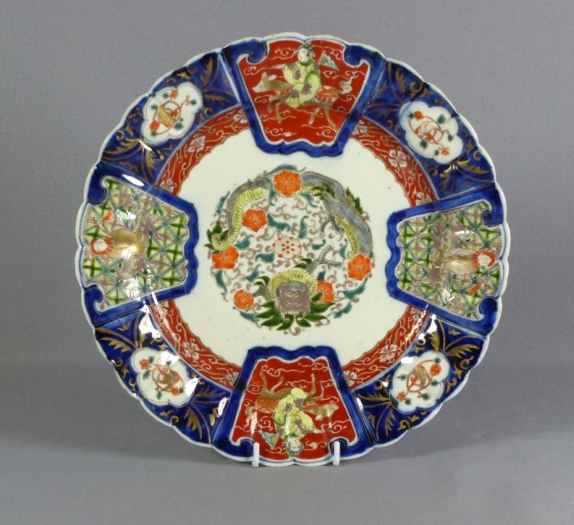 Imari-TellerJapan, 20. Jh.Im Spiegel rundes Ornament mit Drachendekor, auf der Fahne große