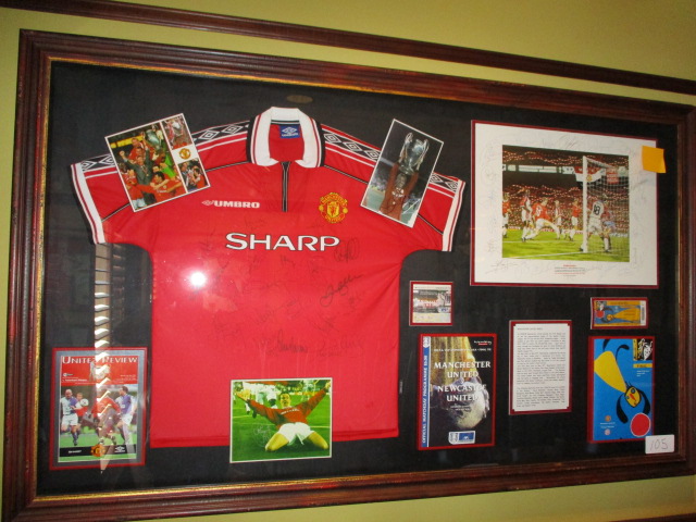 Manchester United treble winners, 1999 shirt and display, 72-1/2in w x 43-1/2in hgt red repilca