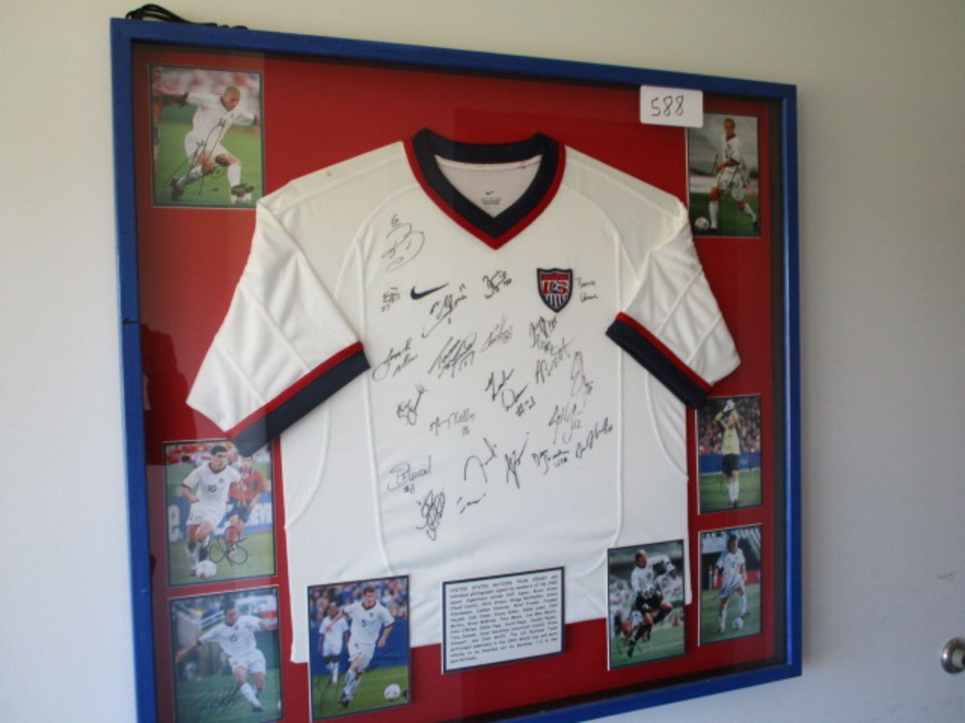 United States National Team signed jersey and photos of 2002 World Cup team, (36-1/2in w x 35in hgt)