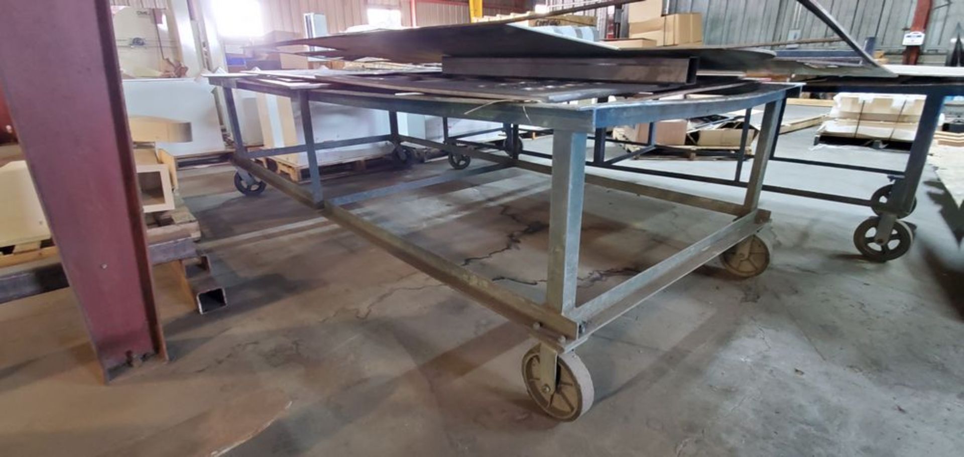 Located in Canon City, CO -- Heavy Duty Rolling Table for steel, mounted on wheels, approximately