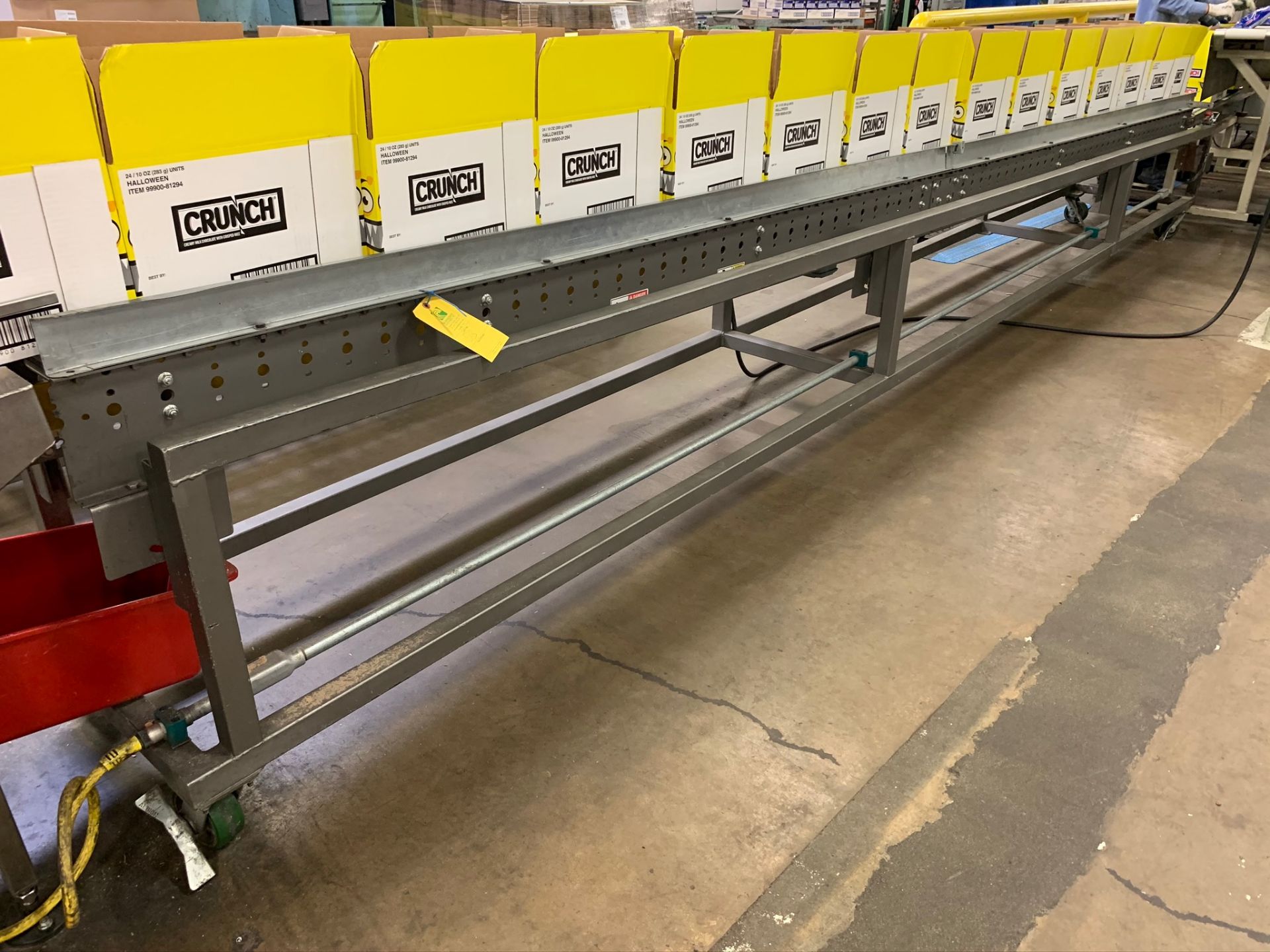 (Located in Burlington WI) Gravity Flow Conveyor for Cases. RIGGING FEE: $1900