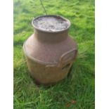 A concrete filled Metal Milk Churn.