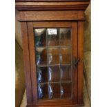A small wall mounted Cabinet with bubble glass.