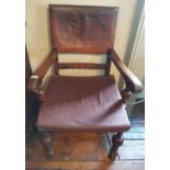 An early 20th Century Oak and Leather Armchair.