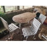 Three white metal and timber Chairs and a table.