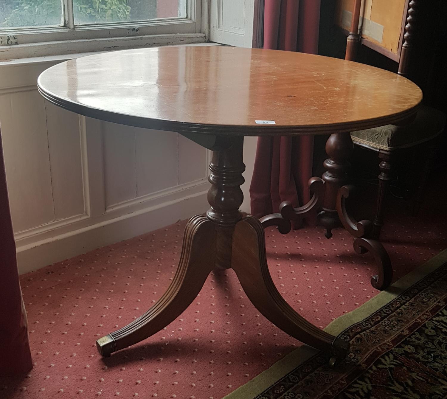 A good Mahogany Circular Supper Table with reeded base and brass toe casters. 90cm diameter.