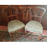 A really good set of six 19th Century Walnut Chairs with highly carved outline.