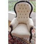 A 19th Century Mahogany show frame Armchair with cream deep buttoned upholstery.