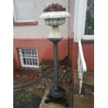 A pair of painted Planters. with urns standing on columned shafts on paw feet.