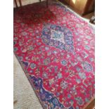 A Red Ground Floral Pattern Iranian Carpet.