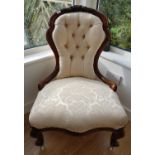 A 19th Century Mahogany show frame Ladies Chair with cream deep buttoned upholstery.