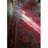 A large Red Ground Persian Mashad Carpet. 385 x 280cm.