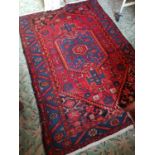 A Maroon and Blue ground Iranian Village Rug.