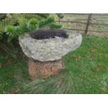 A large Stone Bird Bath.