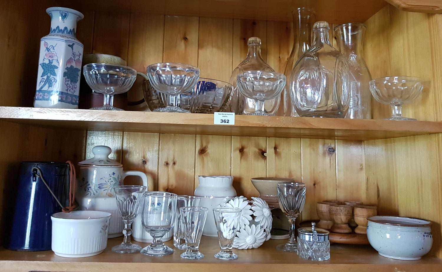 A quantity of Items on two shelves.