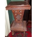 A 19th Century Indian Hardwood Stand with a profusely carved pedestal.