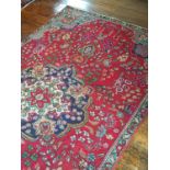 A Red Ground Tabriz Carpet with multi borders.