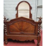 A 19th Century Mahogany Bed with an arch top deep buttoned headboard and solid footboard.