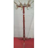 A 19th Century Mahogany Hat Stand with lions head hooks.