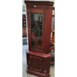 A Mahogany Corner Cabinet with shell detail.