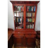 A late 19th Century Mahogany two door Bookcase with glazed upper section and sunken panel door base.