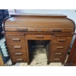 A 19th Century Oak Roll top Desk. (Key in office). 69 x 115 w x 97 cms H.