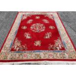 A very large Oriental Carpet with red ground and multi borders.