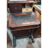 A 19th Century Davenport in need of restoration along with a modern cabinet.