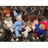 A Pelham Puppet along with other Porcelain dolls and Paddington Bear.