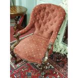 A 19th Century Rosewood Showframe deep buttoned Armchair with carved cabriole front supports.