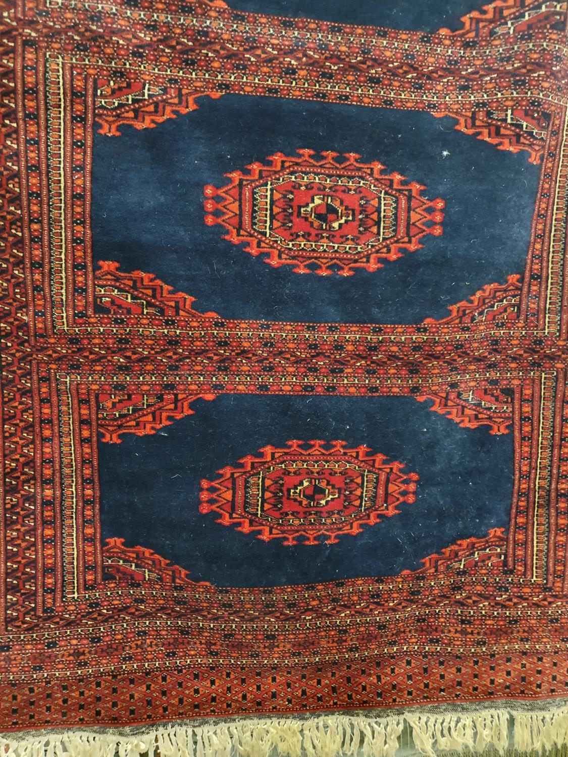 A good Red ground Rug with multi borders and allover decoration. 190 x 123 cms.