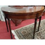 A 19th Century Mahogany Foldover Card Table with turned supports.